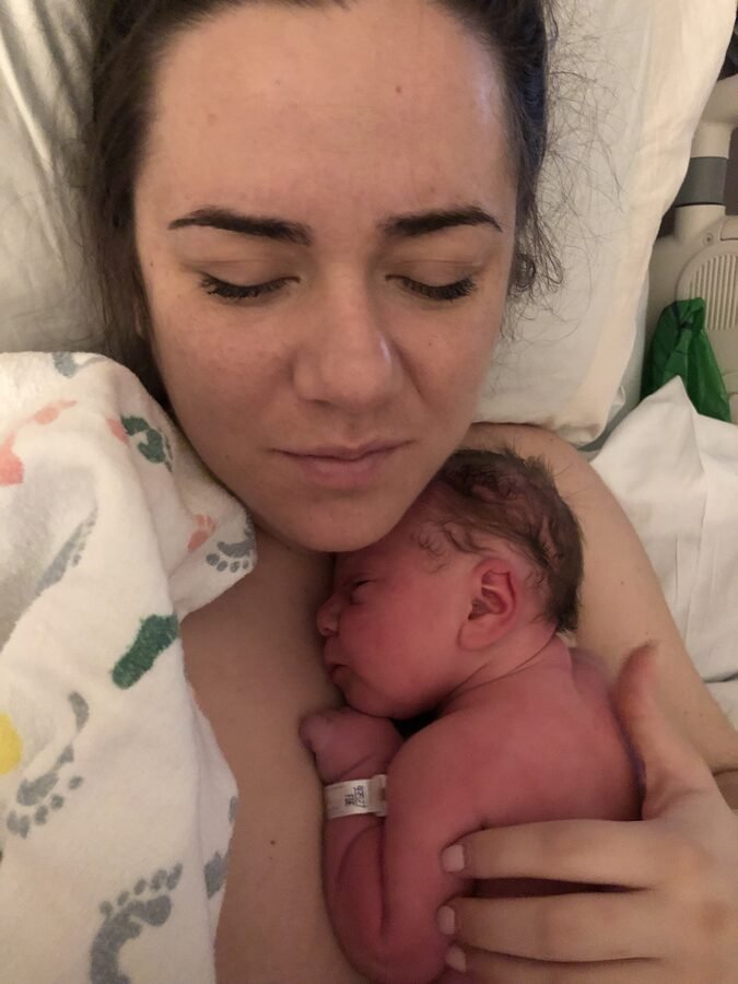 Kate in hospital after surgery, holding her newborn